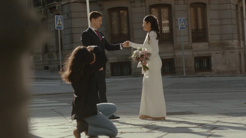 A skilled photographer captures a couple on the street