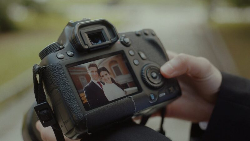 A wedding photographer reviewing photos on their camera